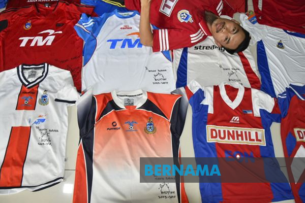 Bernama Isnain showing off his most treasured jerseys.